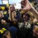 A Michigan fan celebrates with the team on the field after Michigan beat Michigan State 12-10 at Michigan Stadium on Saturday. Melanie Maxwell I AnnArbor.com